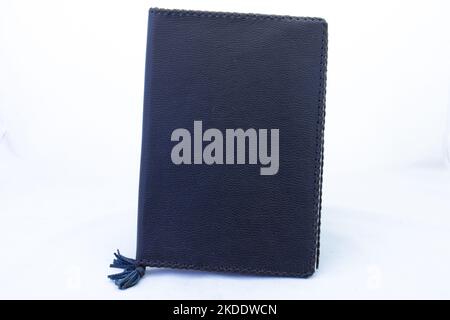 A black leather bound book isolated on a clear background with copy space Stock Photo