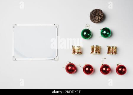 christmas ornaments and decorations on a white background with an empty space in the middle to add your own text or message Stock Photo
