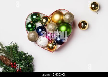 christmas ornaments in a heart shaped box on a white background with copy - space for your text, or image Stock Photo