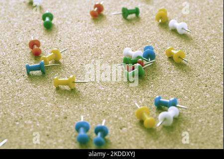 Close up Scattered Colored Map Pins on Top of Brown Cork Board Stock Photo