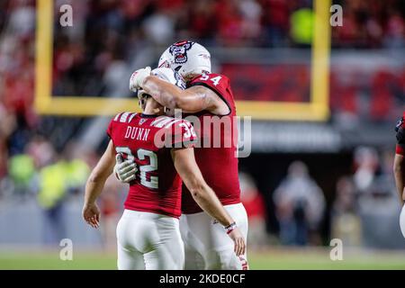 Raleigh, NC, USA. 5th Nov, 2022. North Carolina State Wolfpack place kicker Christopher Dunn (32) is hugged by offensive lineman Dylan McMahon (54) after making a field goal against the Wake Forest Demon Deacons during the second half of the NCAA football match up at Carter-Finley Stadium in Raleigh, NC. (Scott Kinser/CSM). Credit: csm/Alamy Live News Stock Photo