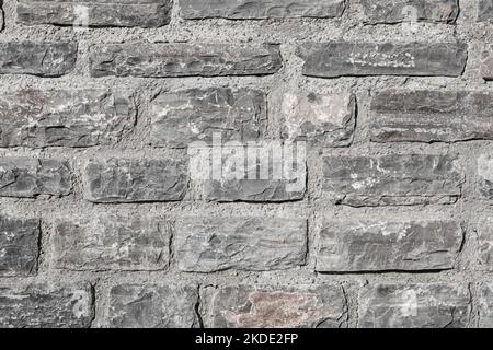 A close up background of grey natural stone wall. High quality photo Stock Photo