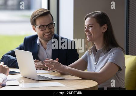 Happy positive employees working together during group meeting Stock Photo
