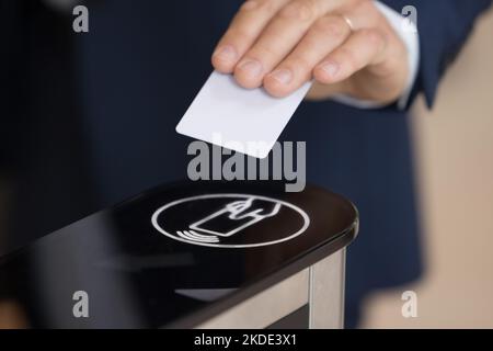Unknown businessman in formal suit uses pass card passing checkpoint Stock Photo