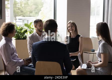 Diverse millennial business team meet in modern office interior Stock Photo