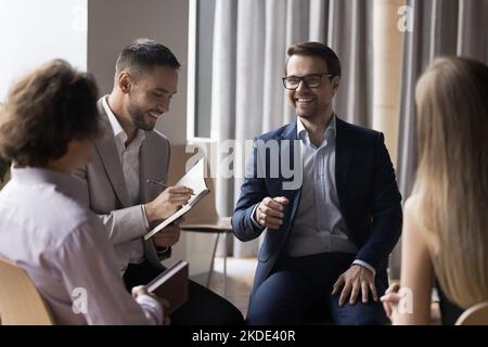 Group of smiling teammates take part in teamwork Stock Photo