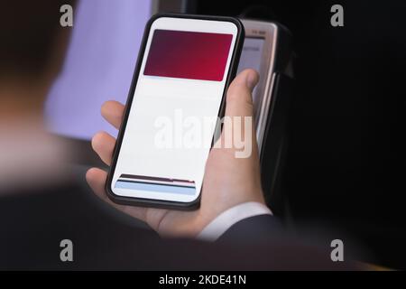 Client makes payment using smartphone and card reader machine Stock Photo