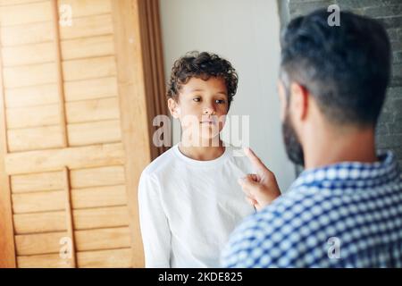 I warned you before. a father disciplining his little son at home. Stock Photo