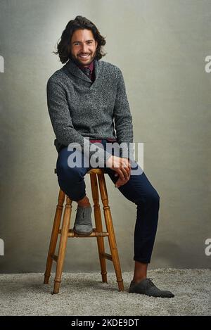 All I can be is myself. Portrait of a stylishly dressed man sitting on a stool in the studio. Stock Photo