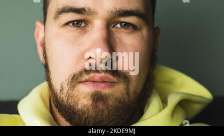 Face of a young man with untrimmed beard and moustache close-up. Selective focus Stock Photo