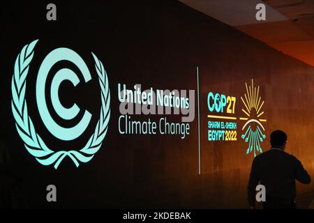 Sharm El Sheikh. 6th Nov, 2022. A man walks past a board showing the 27th Conference of the Parties of the United Nations Framework Convention on Climate Change (COP27) in Sharm El-Sheikh, Egypt, Nov. 5, 2022. The COP27 is to be held from Nov. 6 to18 in Egypt's resort city of Sharm El-Sheikh. Credit: Sui Xiankai/Xinhua/Alamy Live News Stock Photo