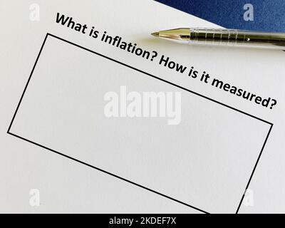 One person is answering question about inflation. He is thinking what is inflation and how to measure it. Stock Photo