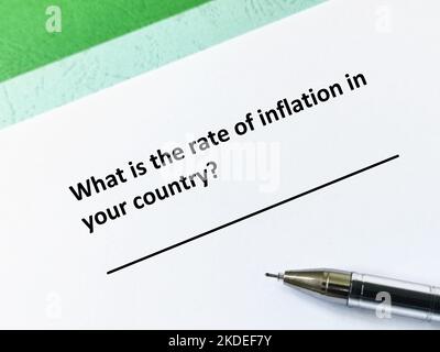 One person is answering question about inflation. He is thinking what is the rate of inflation in his country. Stock Photo