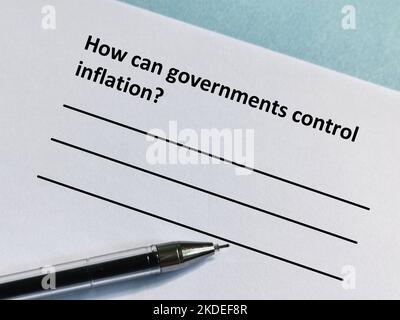 One person is answering question about inflation. He is thinking how can government control inflation. Stock Photo