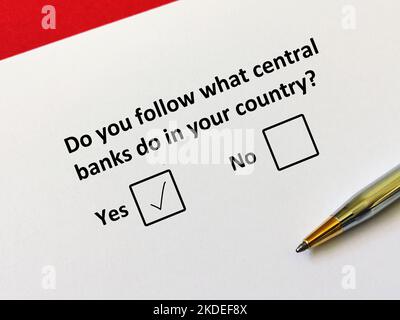 One person is answering question about inflation. He follows what central banks do in his country. Stock Photo