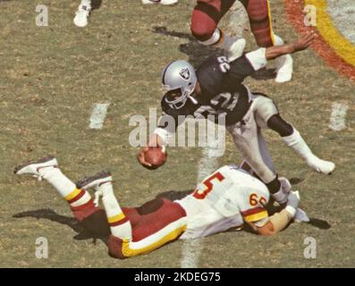 Los Angeles Raiders Marcus Allen (32) comes over the top as Seattles Jeff  Bryant (77) and Michael Jackson (55) grab Allen from behind, Nov. 4, 1985,  Seattle, Wash. Allen ran for 101