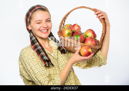 Cook recipe concept. Woman villager carry basket natural fruits. Woman gardener rustic style hold basket with apples on white background. Lady farmer Stock Photo