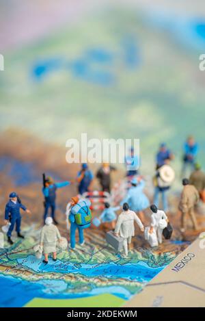 Miniature toy people concept US border patrols against a group of migrant from Mexico Stock Photo