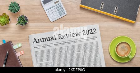 A newspaper on a desk with the headline Annual review 2022 Stock Photo