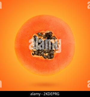 papaya slice on orange color background, Minimal creative food concept Stock Photo