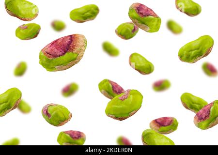 Falling pistachio peeled isolated on white background, selective focus Stock Photo