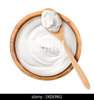sour cream in wooden bowl and spoon, mayonnaise, yogurt, isolated on white background, clipping path, full depth of field Stock Photo