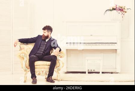Macho attractive and elegant on serious face and thoughtful expression. Elite lifestyle concept. Man with beard and mustache wearing classic suit Stock Photo