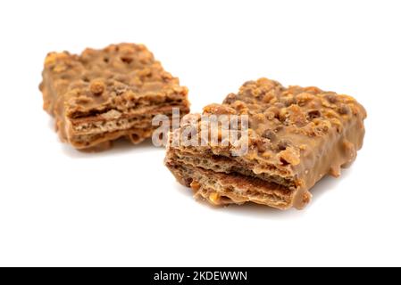 Waffle chocolate bar with nuts broken into two parts close up, isolated on white background Stock Photo