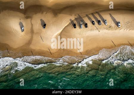 Aerial shot of fishermen and cars at Fraser Island's Seventy Five Mile Beach Stock Photo
