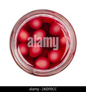 Homemade compote of blue grapes, in an open preserving jar, isolated, from above, on white background. Preserved blue grapes, fresh from the garden. Stock Photo