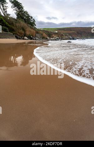 retreating tide on a sandy beach Stock Photo