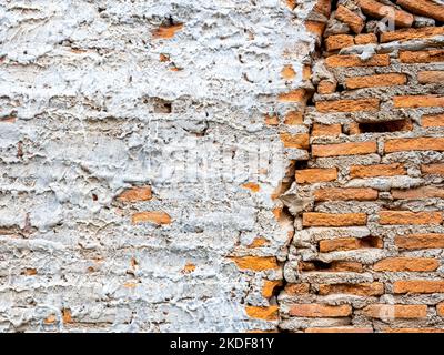 Abstract white grunge peeling cement texture on brick wall background. Old crack plaster concrete wall. Broken stonewall wallpaper. Stock Photo