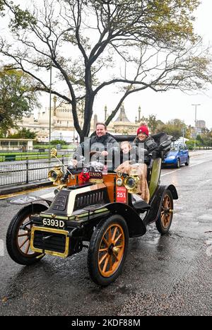 Brighton UK 6th November 2022 - These participants try to stay warm as they arrive in Brighton after taking part in the annual RM Sotheby's London to Brighton Veteran Car Run today . The Run is open to four-wheeled cars, tri-cars and motor tricycles manufactured before 1st January 1905 : Credit Simon Dack / Alamy Live News Stock Photo