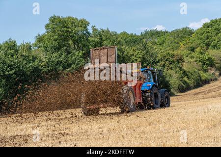 Muck spreading on a field Stock Photo