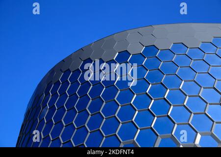 Honeycomb blue glass windows. Part of glazed facade of modern building. Office, shopping mall Stock Photo