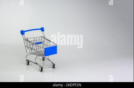 Shopping cart on white background with light and shadow. schopping concept. Stock Photo