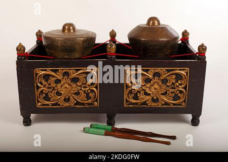 Kethuk Kempyang,  an Indonesian musical instrument used in the Javanese gamelan. Bronze gongs balanced on string with a decorative wooden frame. Stock Photo