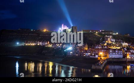 The ruins of Whitby Abbey and harbour at nighttime during its Dracula celebrations in October 2022 Stock Photo