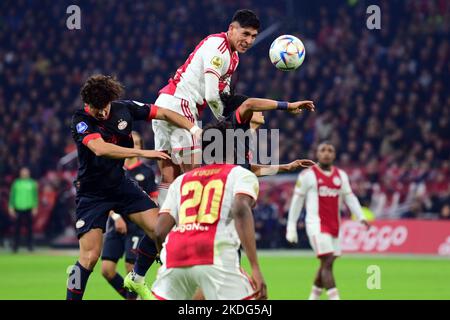 AMSTERDAM - (LR) Andre Ramalho of PSV Eindhoven, Lorenzo Lucca of Ajax  scores the 1-2, Jordan Teze of PSV Eindhoven during the Dutch Eredivisie  match between AFC Ajax and PSV at the