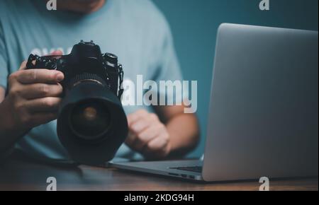 Young man learning to use and setting DSLR camera from video online course. Stock Photo
