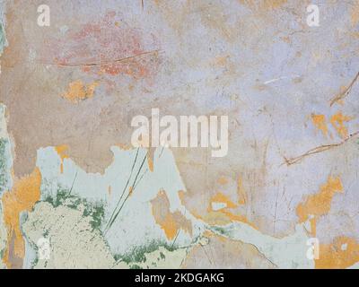 Multi Colored layers of old plaster. Texture of rough cracked pink stucco texture background. Decorative plaster on the wall. Stock Photo