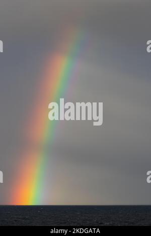 Rainbow over the Atlantic ocean off the west coast of Scotland Stock Photo