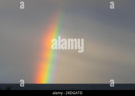 Rainbow over the Atlantic ocean off the west coast of Scotland Stock Photo