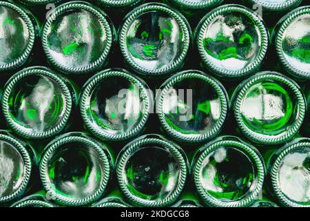 Glass bottles green. Green glass bottles of beer. Wall formed by green bottles. Green bottles background. Empty Glass Bottle with Lighting Stock Photo
