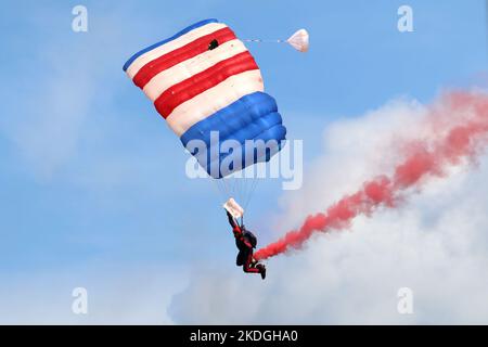 Kleine Brogel, Belgium - SEP 08, 2018: UK Defence RAF parachutists giving a show with smoke on an air show at Kleine Brogel, Belgium. Stock Photo