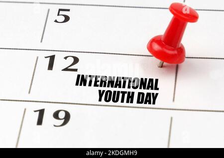 International holidays. On the calendar grid, the date and name of the holiday - International Youth Day Stock Photo