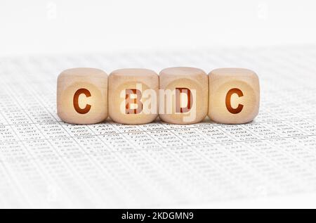 Business concept. On the table with documents are wooden cubes with the inscription - CBDC Stock Photo