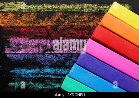 Colored crayons on a black board. Imagination concept. Stock Photo