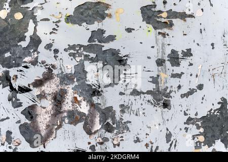 Abstract grungy stained peeled wall background with burnt paint close up Stock Photo