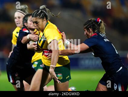 Australia's Shannon Mato (centre) tackled by France's Jeanne Bernard (right) during the Women's Rugby League World Cup Group B match at the LNER Community Stadium, York. Picture date: Sunday November 6, 2022. Stock Photo